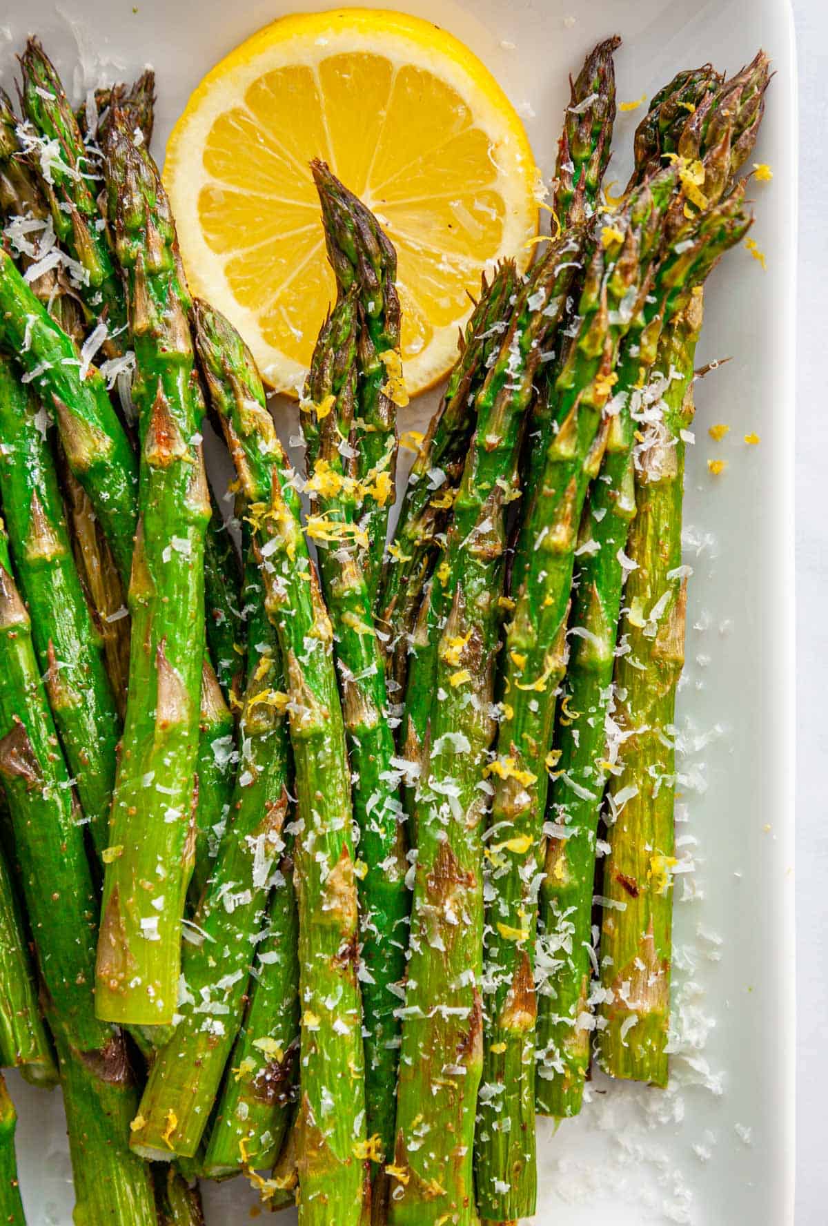 close up of roasted asparagus with parmesan and lemon