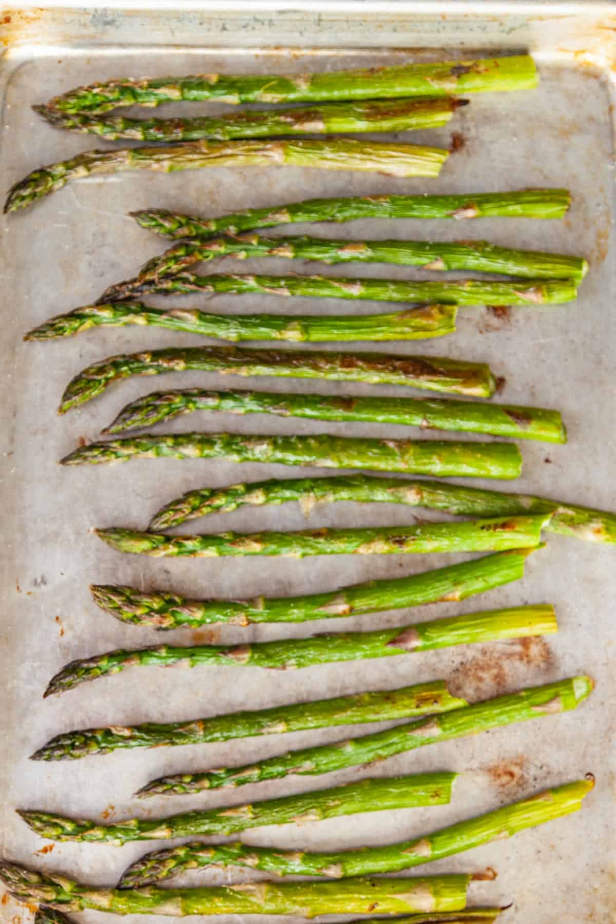 roasted asparagus spears on a sheet pan