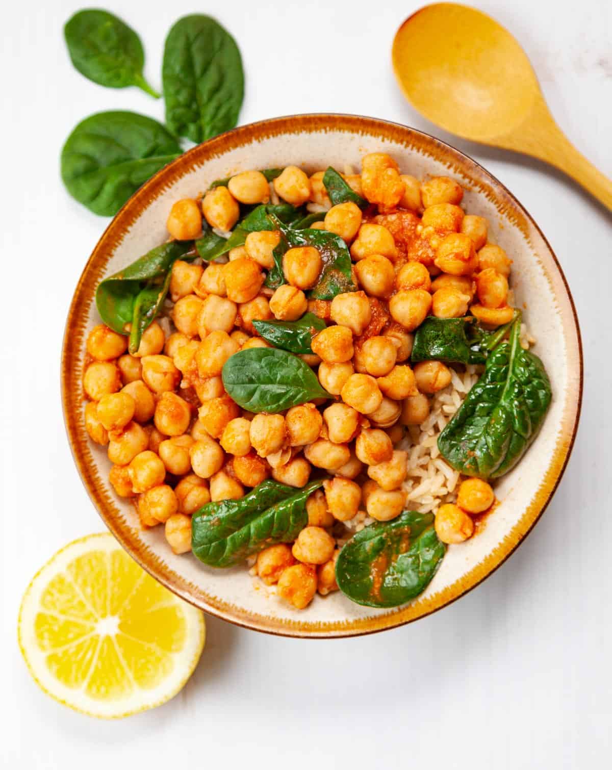 cooked chickpeas in a bowl with baby spinach