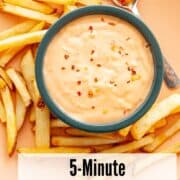 a bowl of creamy, spicy red dipping sauce with french fries