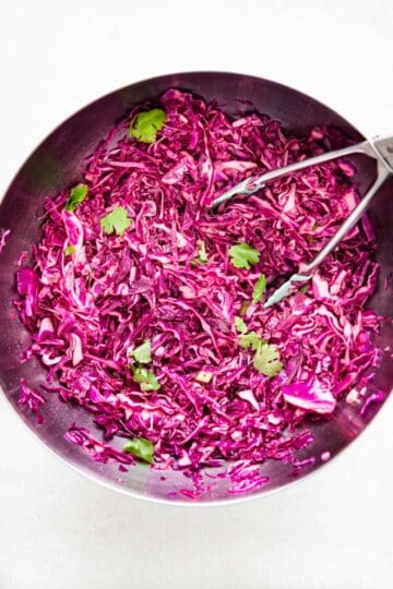 a big bowl of red cabbage coleslaw