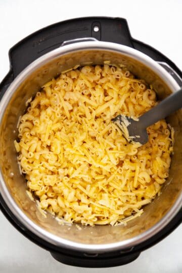 grated cheese and milk added to cook elbow macaroni