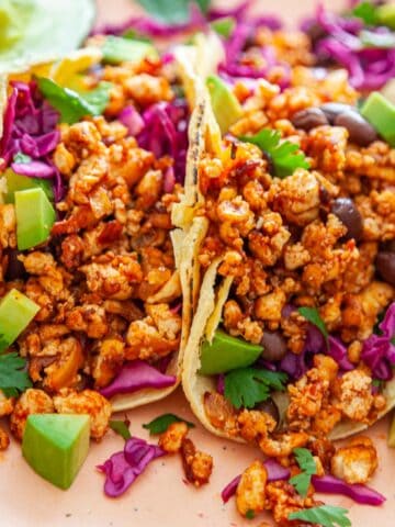 close-up of tofu tacos with toppings in corn tortillas