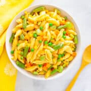 a bowl of mini shell pasta with cooked frozen vegetables