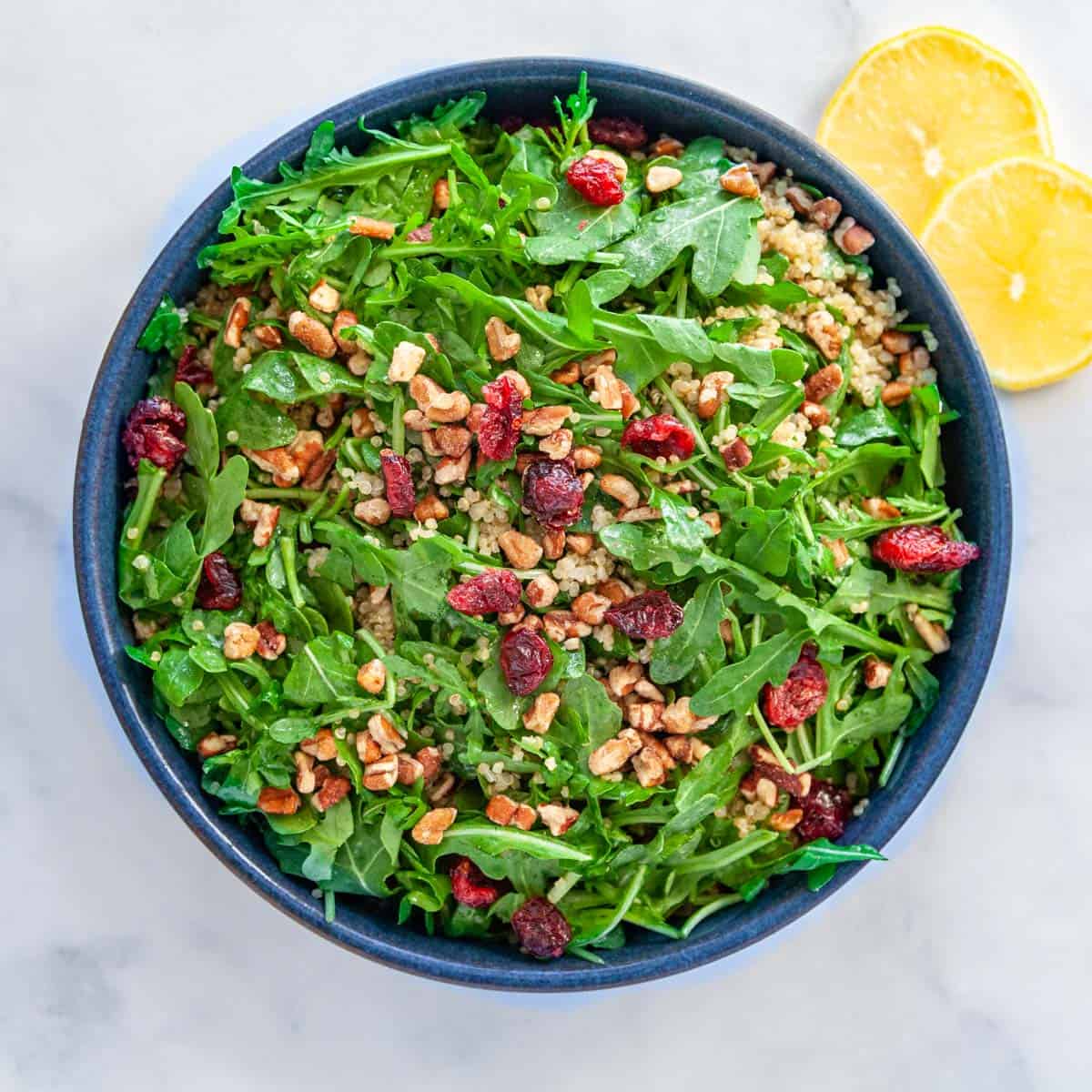 a bowl of arugula and quinoa salad