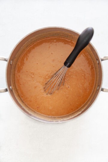 Smooth refried beans whisked in a soup pot.