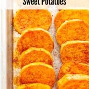 Roasted sweet potato rounds with spice on a baking sheet.