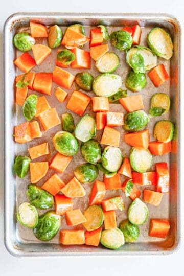 A sheet-pan of Brussels sprouts and sweet potatoes.