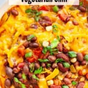 A bowl of vegetarian bean chili with melted cheese.