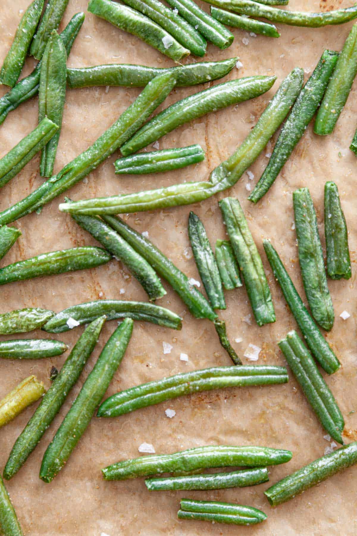 A sheet-pan of green beans with sea salt.