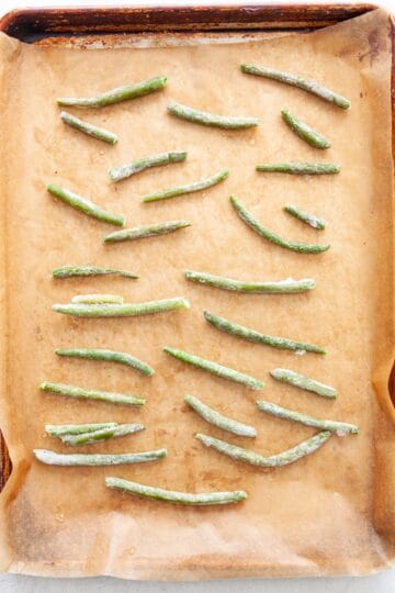 Frozen green beans on a sheet-pan.