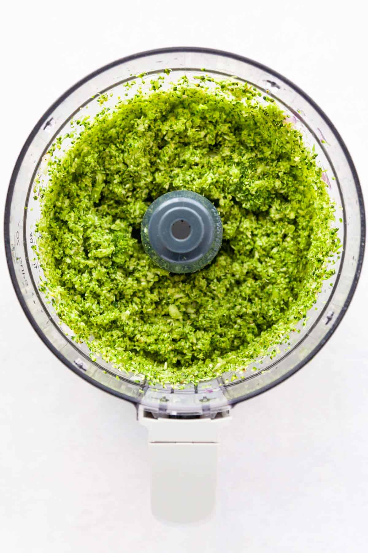 Finely chopped broccoli in a food processor.