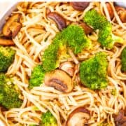A bowl of rice noodles with roasted vegetables.